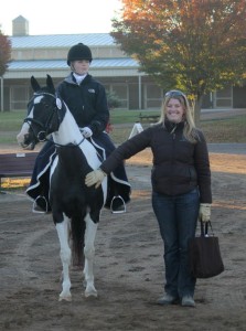 Lauren Sprieser helps a student get ready for a dressage test